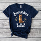 Navy blue t-shirt with a dog graphic and text on a wooden surface